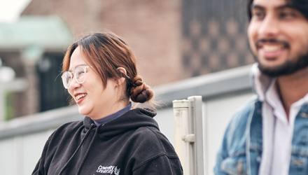 Students sitting outside on Coventry university campus 