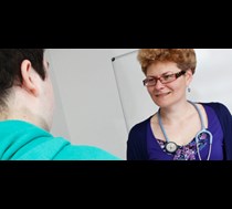 female doctor smiling at another person 
