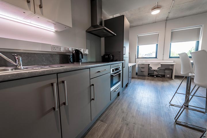 Kitchen area worktops and over with a dining table on the side