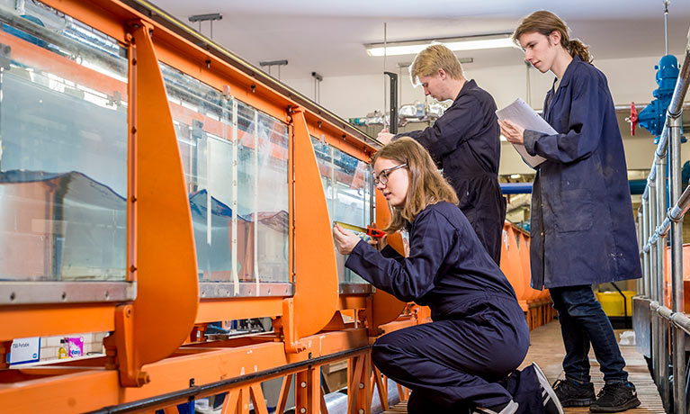 Students working on hydraulics system.