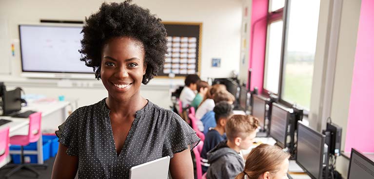 A teacher smiling in class