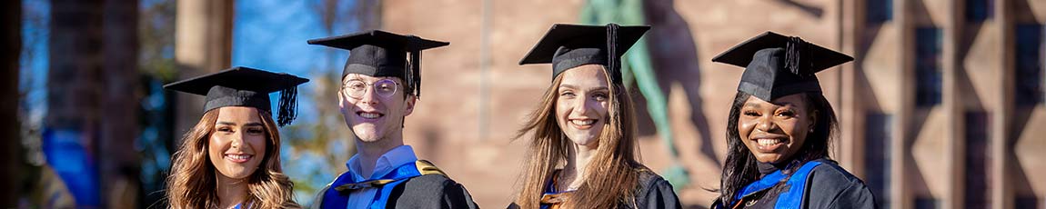 Group of graduates wearing hats and gowns after graduation