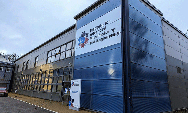 photo of the outside of the AME building. The building is grey but with a large vertical blue strip which contains the AME logo on a white background