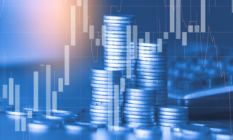 Stack of money coins with a trading graph