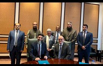 Group of Coventry University and Pakistani educational institute leaders gathered round table signing document