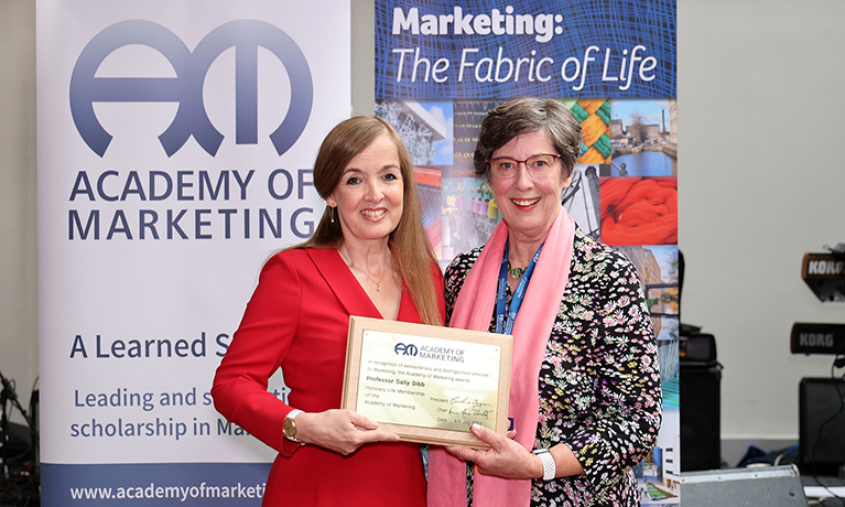 Sally Dibb being presented with a certificate for her lifetime achievement award for marketing