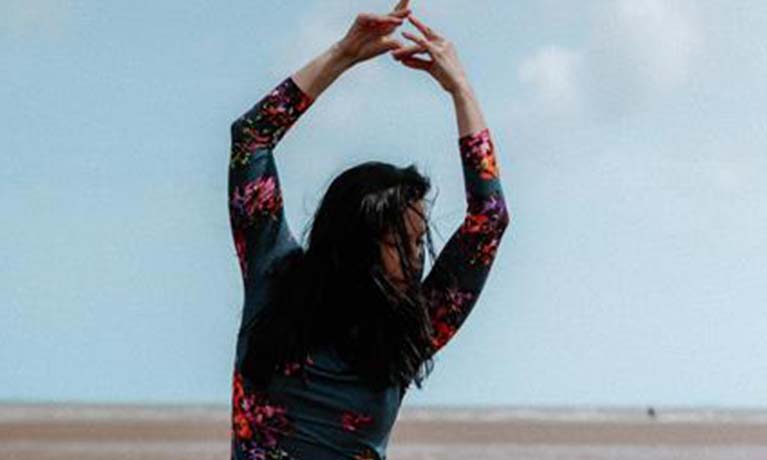 Woman performing on a beach