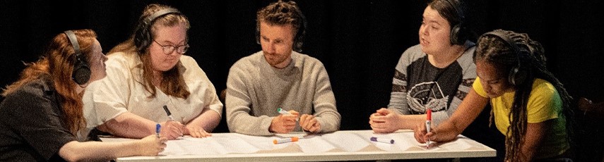 Five people sat around a table