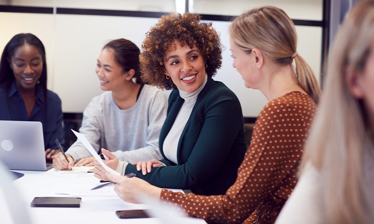 A group of women sat around a table working