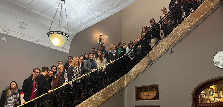 A group of people standing on an ornate staircase