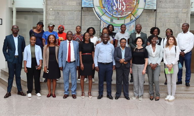 Project team stood outside building in Kenya