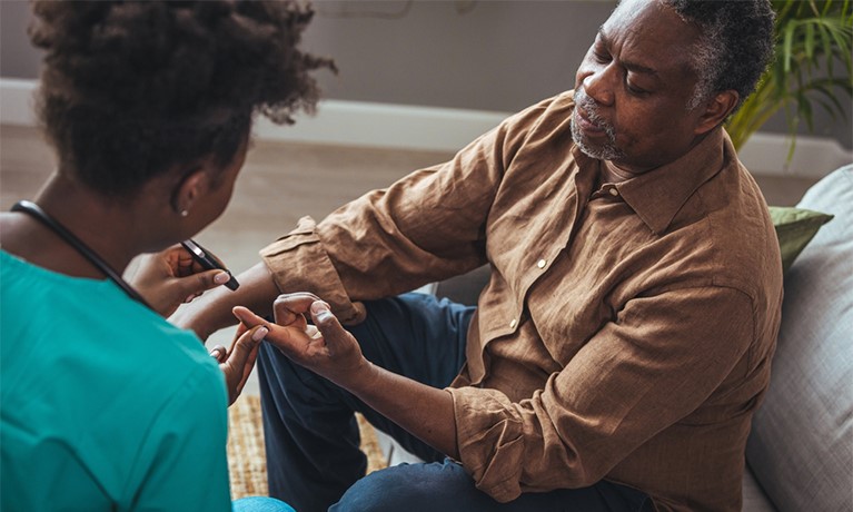 Man getting his blood sugars tested by healthcare professional