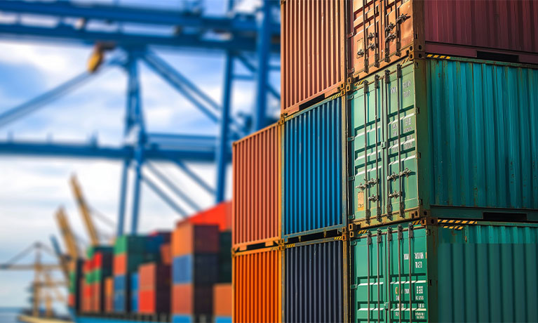 Stacked shipping containers at busy port
