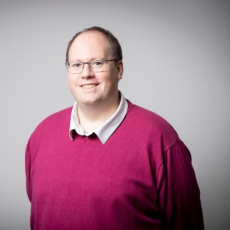 Matthew England smiling during photoshoot