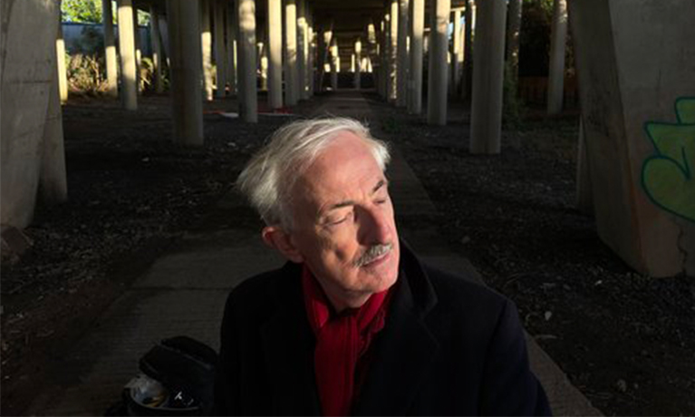 Man with closed eyes and a red scarf