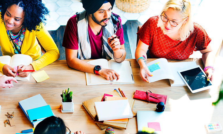 Group of adults sat around a table brainstorming