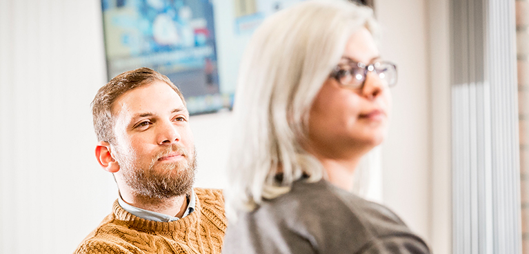 A man and woman looking to the right