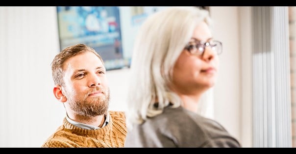 A man and woman looking to the right