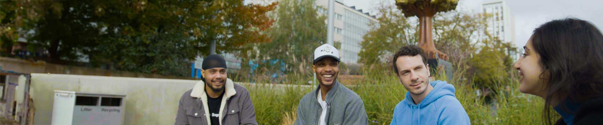 group of students sitting outside on campus