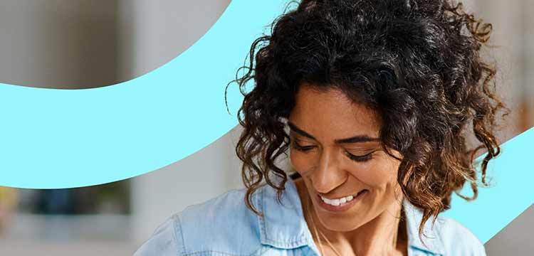 Female smiling looking down with a turquoise blue swirl in the background