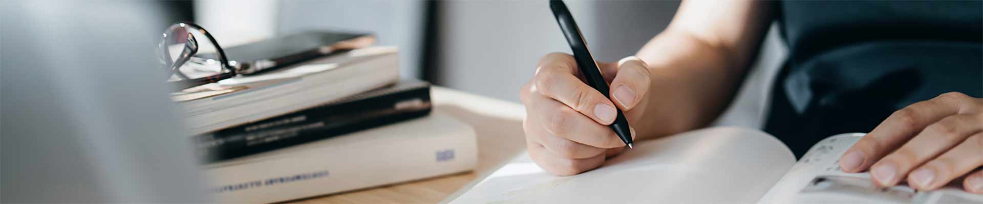 three men wearing yellow vests and hard hats looking over construction plans