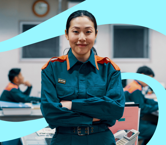 Female wearing a emergency uniform in a office with other emergency  officers in the background