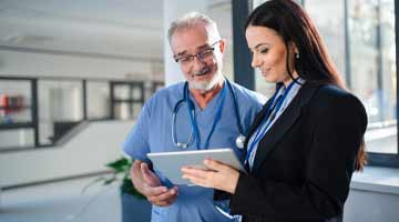 Two people looking at a tablet