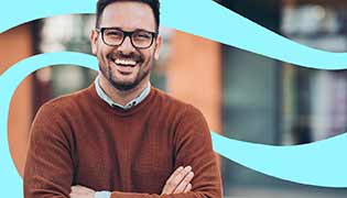 Smiling male wearing glasses with folded arms looking forward