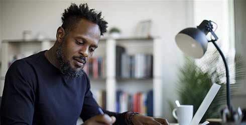 Black man sitting at a desk 