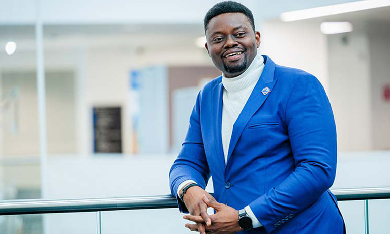 Edward Ileomoh portrait in campus building