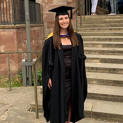 Hannah wearing her graduation gown at the old Cathedral