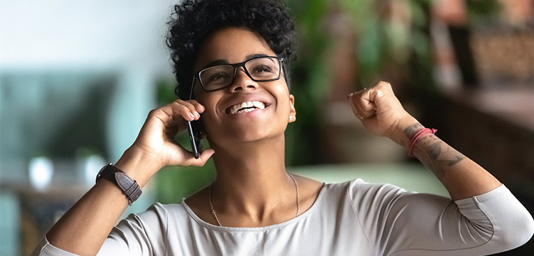 young BAME woman on phone 767x368.jpg