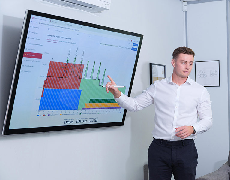 Dan teaching and pointing at a presentation on the screen