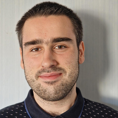 A close up portrait of Tomasz with a white background
