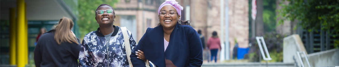 A young student next to The Hub with their parent at a Coventry University Open Day