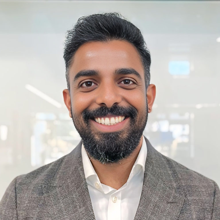 Headshot of John Chellian smiling at the camera