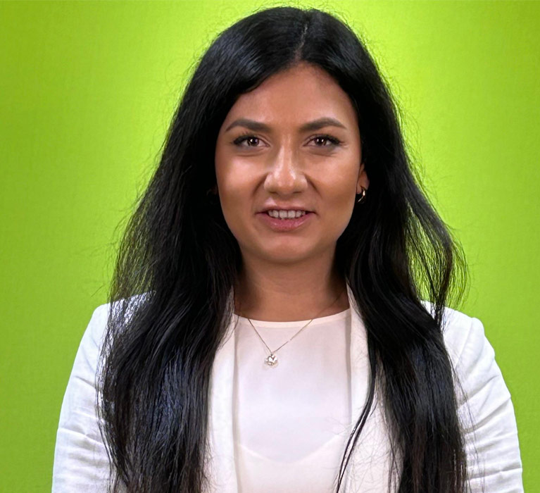 Portrait of Andreea Willmott with a lime green background