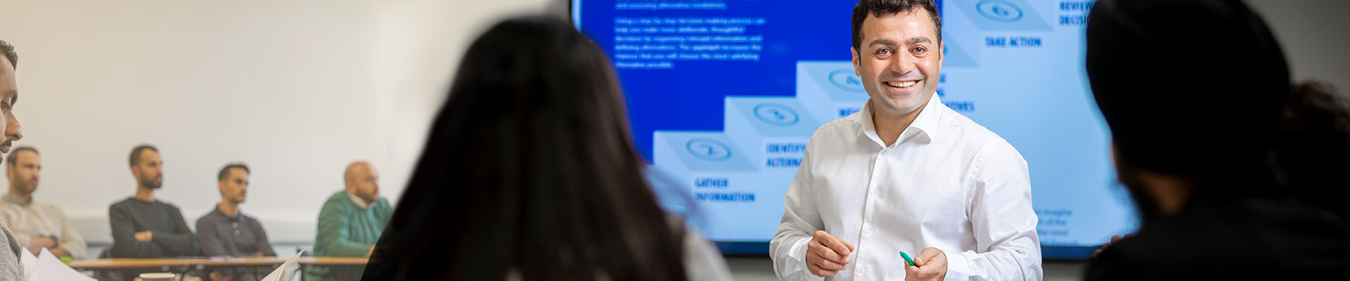 Man presenting infront of digital screen
