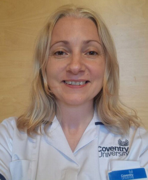 A man sitting down and smiling