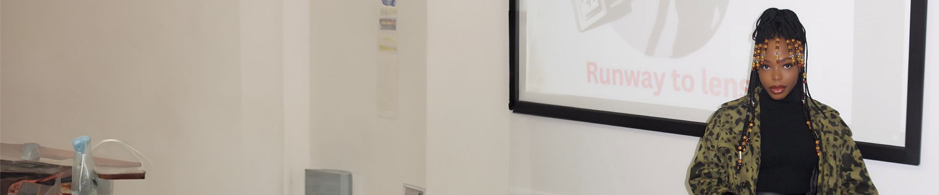 Laura Onome Momodu wearing a long animal print coat wearing beads in her hair