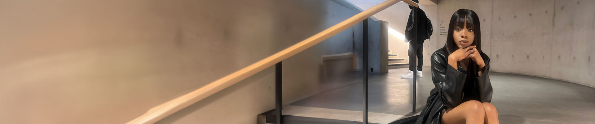 Laura Onome Momodu sitting on a stairwell