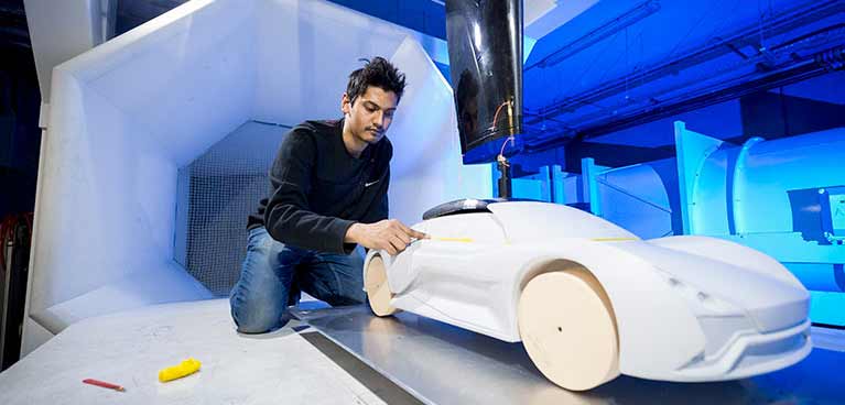 Young student polishing a model car