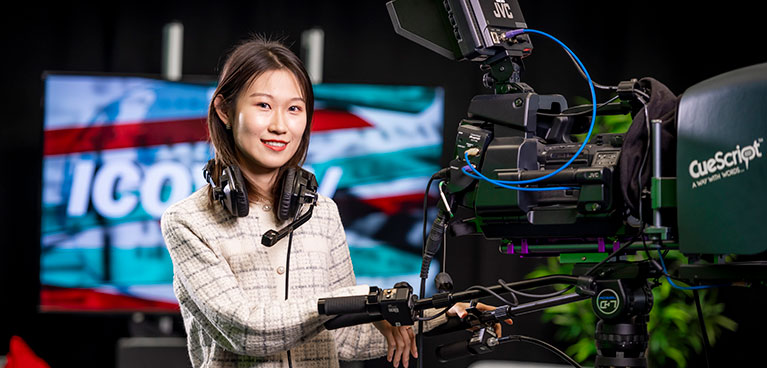 Student handling a camera