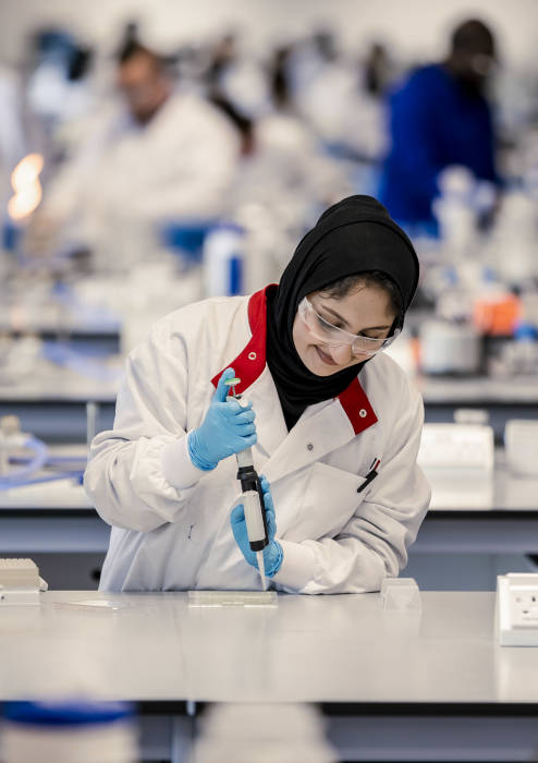 Woman wearing a lab coat in a laboratory