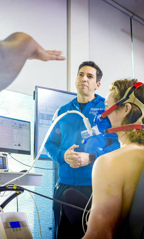 Lecturer stood in front of a male with an  oxygen mask