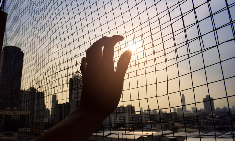 Close up of hand on a fence