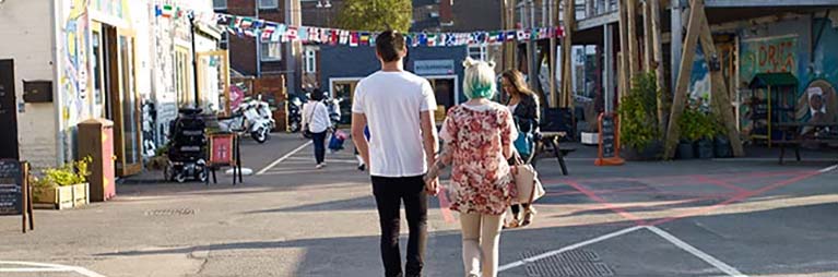 Two people walking in FarGo Village