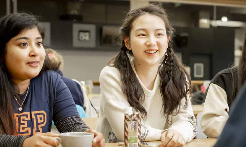 Close up of female international students chatting