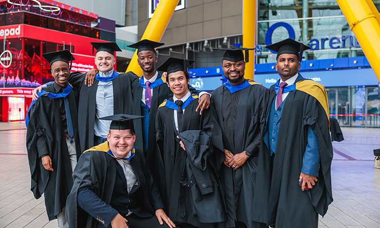 Seven new graduates at CUL graduation celebrating, Rosvelt is in the centre