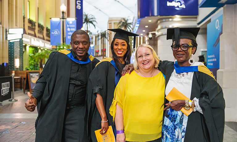 New graduates at CUL graduation celebrating